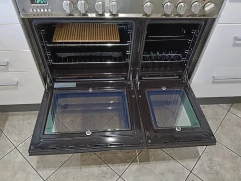 A cleaned double oven with both doors open