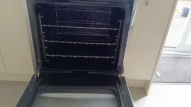 A clean oven with racks in place after cleaning